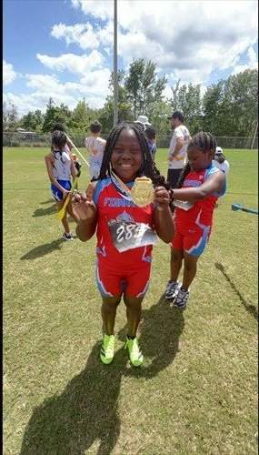 Spartans track athlete showing her medal